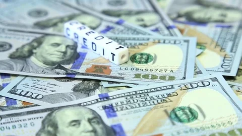 Word from cubes "credit" on the spinning surface of American dollars Stock Footage 70580832