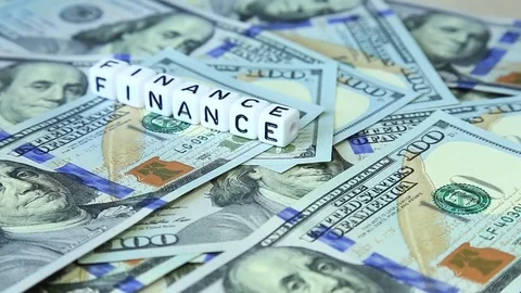 Word from cubes "finance" on the spinning surface of American dollars. Stock Footage 70580814