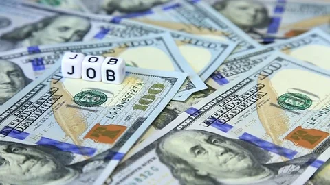 Word from cubes "job" on the spinning surface of American dollars. Stock Footage 70580671