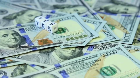 Word from cubes "yes" on the spinning surface of American dollars Stock Footage 70580845