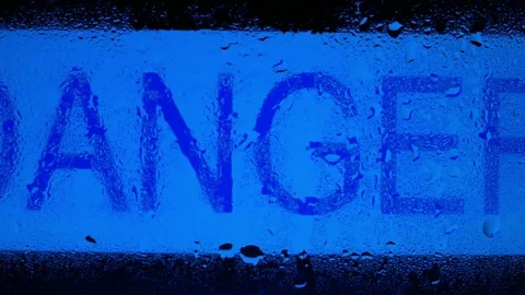 The word 'DANGER' covered by raindrops Stock Footage 80809454