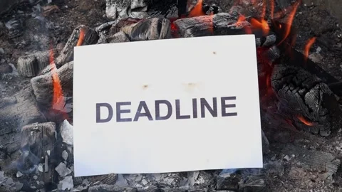 Word Deadline on a white sheet of paper burns into a fire against. Slow motion Stock Footage 139049397