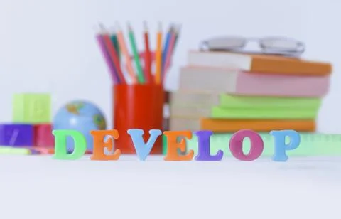 Word develop on blurred background of school supplies .photo wit 스톡 사진