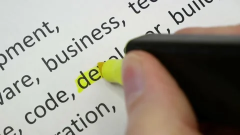 Word developer undelnines among other words printed on white paper. Software  Stock Footage 168489459