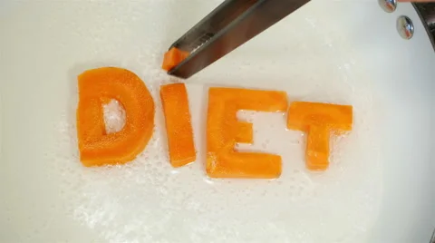 Word Diet collected from letters, which are carved from carrots Stock Footage 57738205
