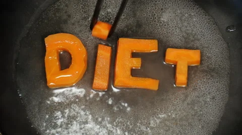Word Diet collected from letters, which are carved from carrots Stock Footage 57745780