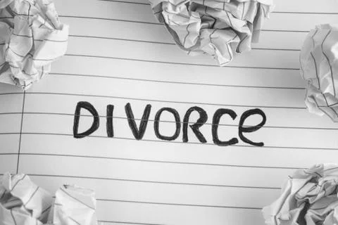 Word Divorce On Notebook Sheet With Some Crumpled Paper Balls On It Stock Photos