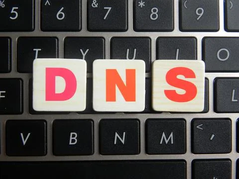 Word DNS (Domain Name System) on keyboard background Stock Photos