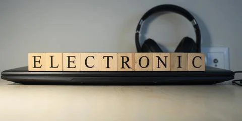 The word electronic is written. computer and headset concept on the background Stock Photos