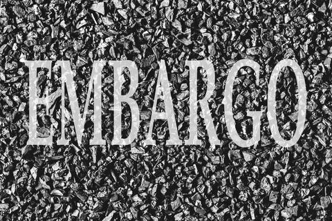 The word Embargo on a background of coal. The concept of an embargo on the su 写真素材