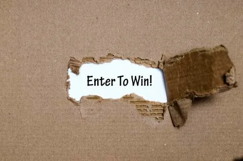 The word enter to win appearing behind torn paper Stock Photos