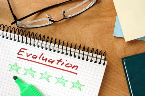 Word evaluation on the notepad and charts. Stock Photos