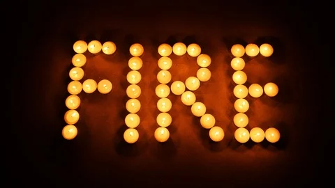The word FIRE written with candle lights. Time lapse. Stock Footage 98095623