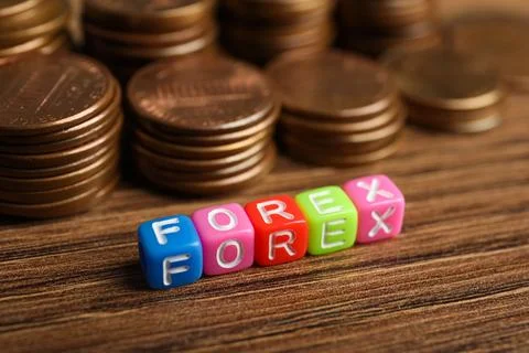 Word Forex made of colorful cubes with letters and stacked coins on wooden .. Stock Photos