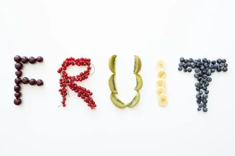 Word fruit on white background of different fruits for each letter.Concept .. Stock Photos