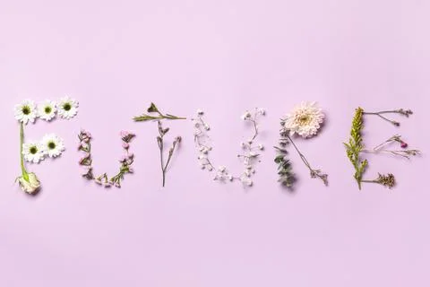 Word FUTURE made of beautiful spring flowers on purple background Stock Photos
