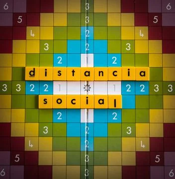 A word game board with “Distancia social-Social distancing” phrase depict Stock Photos