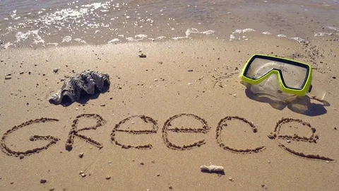 The word Greece on the sand Stock Footage 83650982