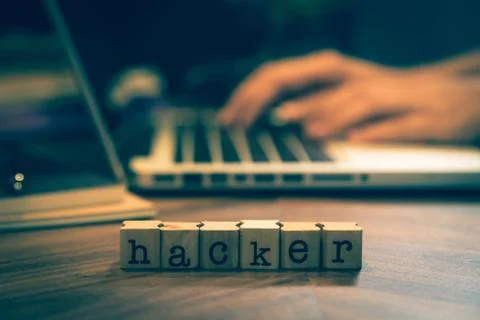 Word Hacker with hands working on notebook. Stock Photos