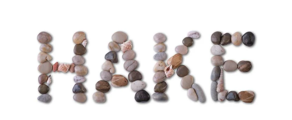 The word "HAKE" is lined with shells and stones of different shapes and color Stock Photos