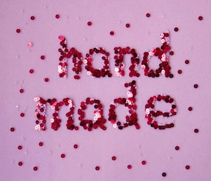 Word "hand made" of sequins. Stock Photos