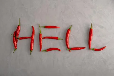 Word Hell is lined with pods of ripe red hot chili peppers Foto stock