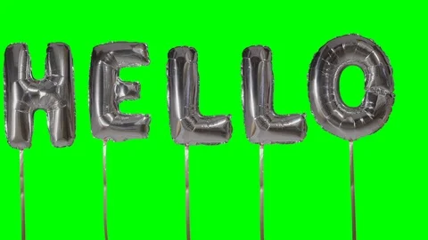 Word hello from helium silver balloon letters floating on green screen Stock Footage 104701448