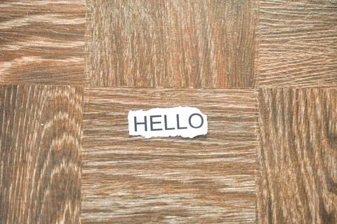 The word "HELLO" printed on a piece of torn white paper. 스톡 사진