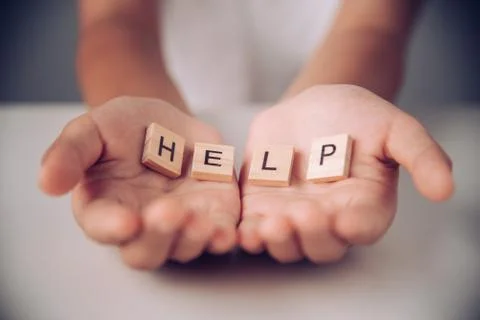 The word "HELP" in hands in cupped shape. Stock Photos
