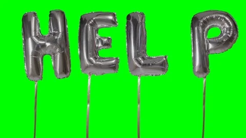 Word help from helium silver balloon letters floating on green screen Stock Footage 104703632
