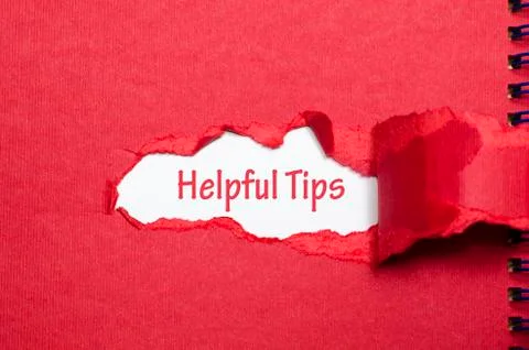 The word helpful tips appearing behind torn paper Stock Photos