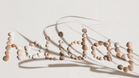 Word holiday written with shells - on white background (FULL HD) Video stock 118207257