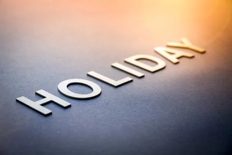 Word holiday written with white solid letters Stock Photos