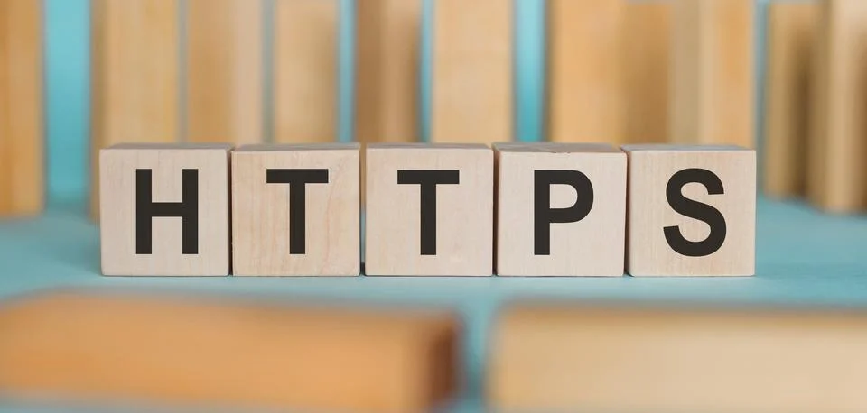Word HTTPS Formed By Wooden Blocks On A blue background Stock Photos