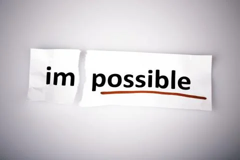 The word impossible changed to possible on torn paper Stock Photos