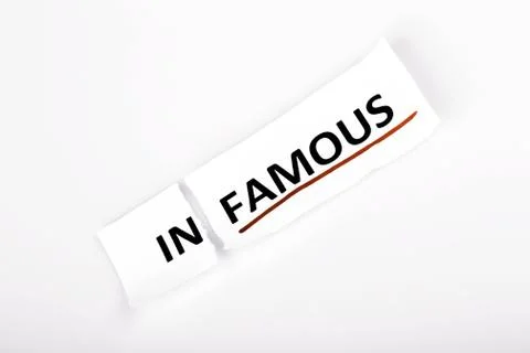 The word infamous changed to famous on torn paper Stock Photos