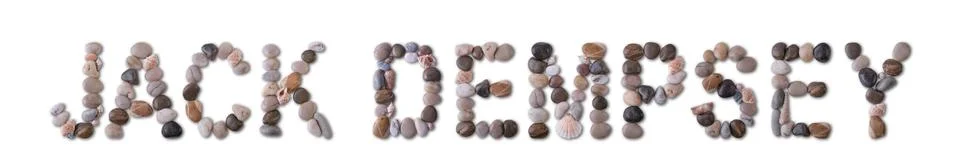 The word "JACK DEMPSEY" is lined with shells and stones of different shapes a Stock Photos