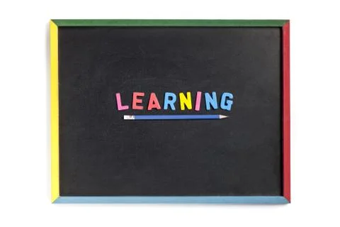 Word learning made of plastic alphabet  on black board Stock Photos
