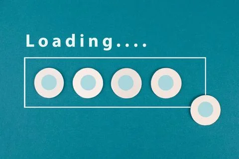 The word loading is standing over the progress bar, hand puts last cube to... Stock Photos