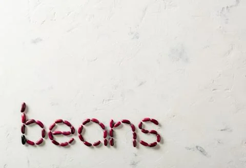 Word made up of beans red beans. White stone background. Stock Photos