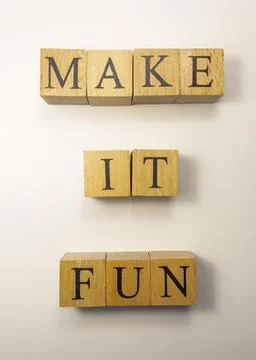 The word Make it fun was created from wooden cubes. entertainment concept. Stock-Fotos