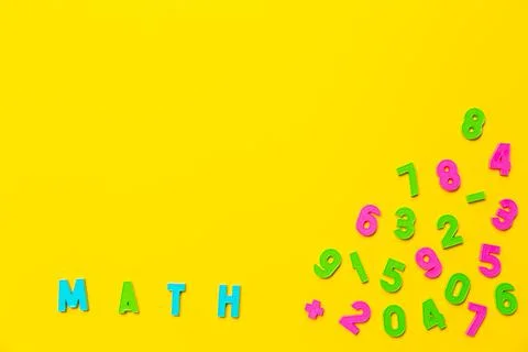 The word math on a yellow background. Copy space. Colored plastic letters. Stock Photos