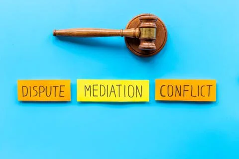 Word mediation on office table between conflict and dispute. Top view Stock Photos