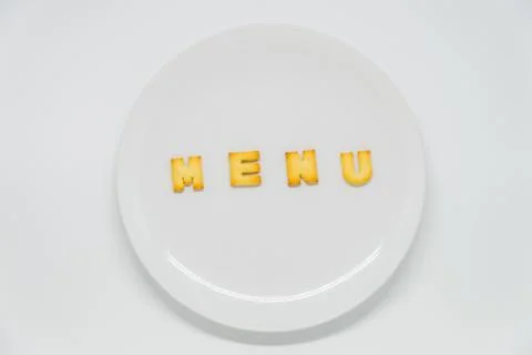 Word MENU cracker on dish with white background Stock Photos
