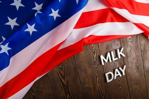 The word MLK day laid with silver metal letters on wooden surface with crumpled Foto stock
