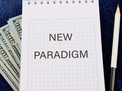 The word New Paradigm in a notebook in a composition with American hundred do Foto stock