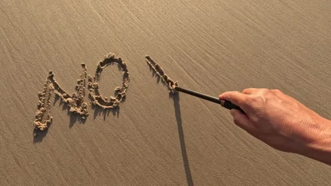 The word  "no wor" written by hand on the beach sand 動画素材 245709853
