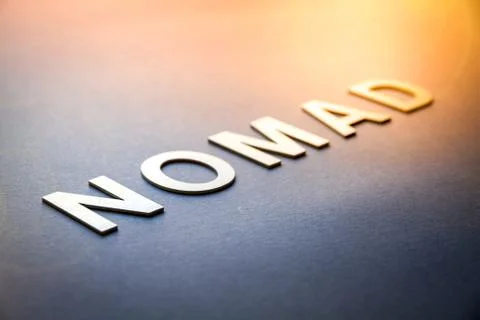 Word nomad written with white solid letters 스톡 사진