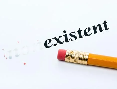Word nonexistent existent with eraser close-up Stock Photos