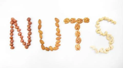The word nuts made up of different types of nuts. Vitamin organic protein foo Stock Photos